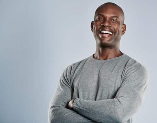 laughing african man in gray shirt with copy space picture id683526534 500x392 1