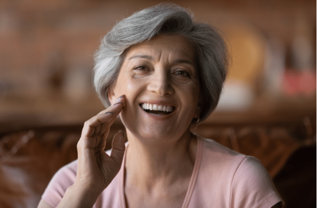 mature grey haired woman looking at camera and smiling
