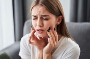 Girl suffering from toothache at home