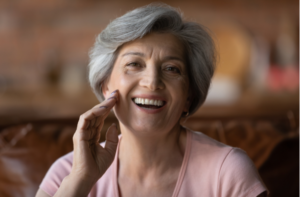 mature grey haired woman talking, looking at camera, smiling