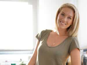 Blond woman using laptop at home