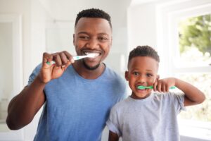Portrait,Of,A,Dad,Brushing,His,Teeth,With,His,Child