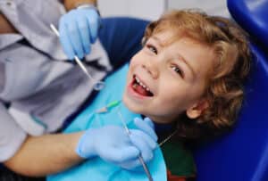 Happy child in dentist’s chair