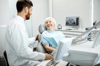 Dentist with older patient during family dental visit