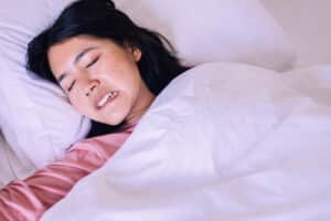 Woman grinding her teeth while sleeping