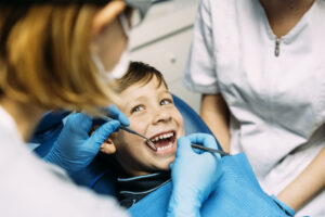 Dentist treating a young boy during a dental visit in Mesa, AZ