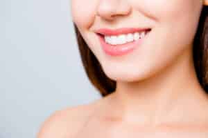 Woman smiling and showing healthy teeth after improving her gum health
