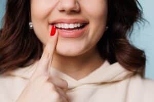 Woman smiling with restored front teeth after porcelain veneer treatment