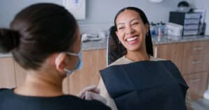 Dentist examining a patient for tooth sensitivity or cavities.